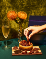 Hand reaching for candied pecans