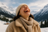 photo of woman smiling on vacation in the winter and she's laughing and lookng up so you really don't see her face