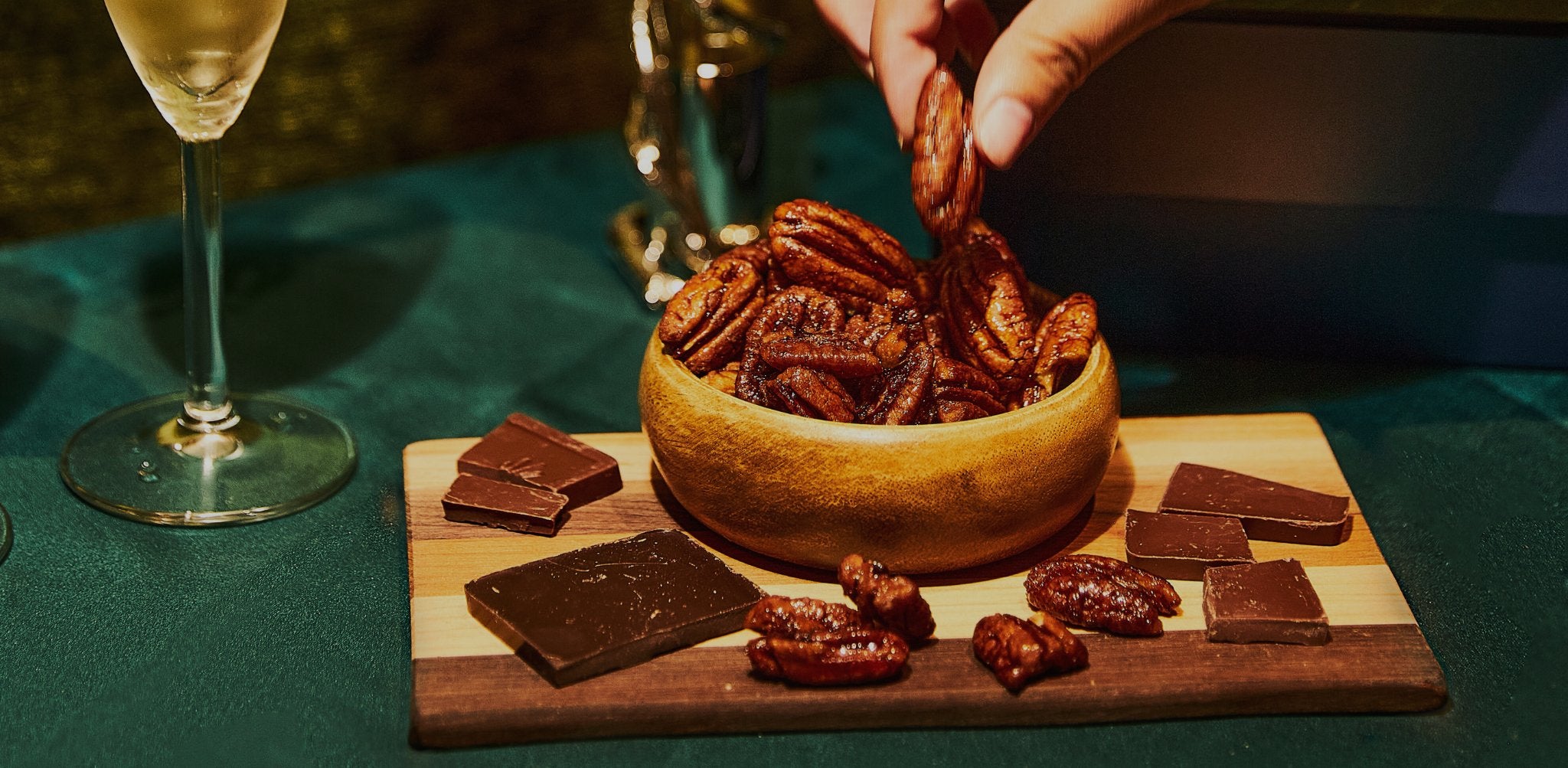 pecans and chocolate in a wooden bowl